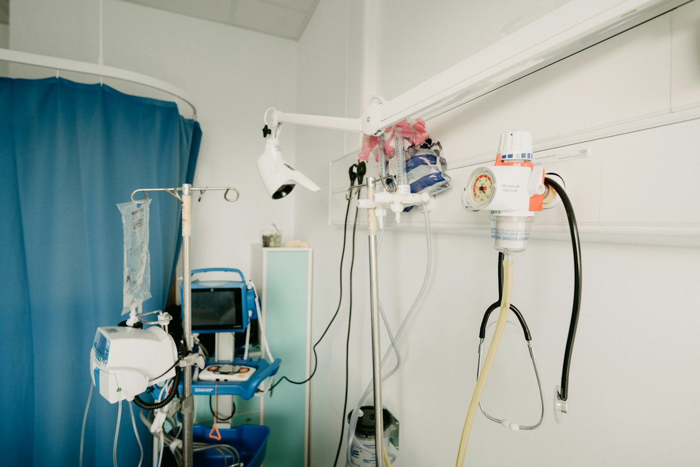 Medical equipment in a clean clinic room with an IV drip.